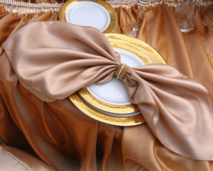 Shining Fabric Enhanced By A Delicate Ring Lends Opulence. Image Provided By Square Root Event Design