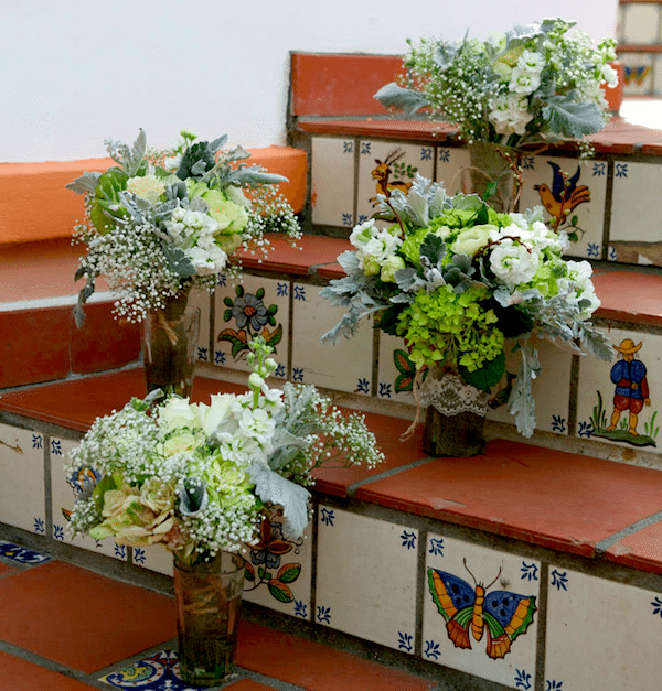 A touch of lace and baby’s breath and dusty miller create delicate beauty. Joel Austell Studios