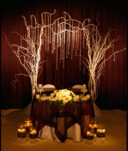 Tree branches and crystals create a fabulous setting for a cake Image provided by The Finishing Touch Event Design