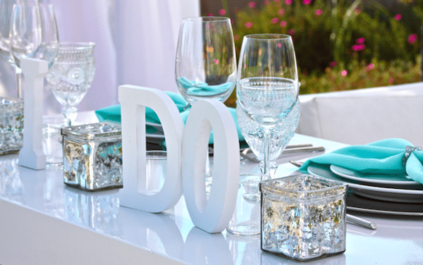 Personalize a head table with just the right sentiment. Image provided by Signature Party Rentals