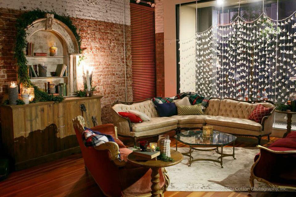 This is an eclectic holiday look using mix & match vintage furniture with traditional plaid throws, old books accented with candles and fresh greens. - Kevin Covey - Blue Cotton Reception Lounge